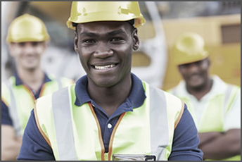 Smiling employee wearing a safety helmet